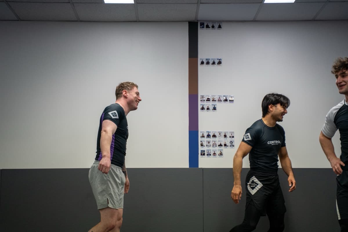 Coach correcting a student's grip mid-drill at Control Martial Arts